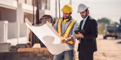 Engineers reviewing infrastructure plans on site